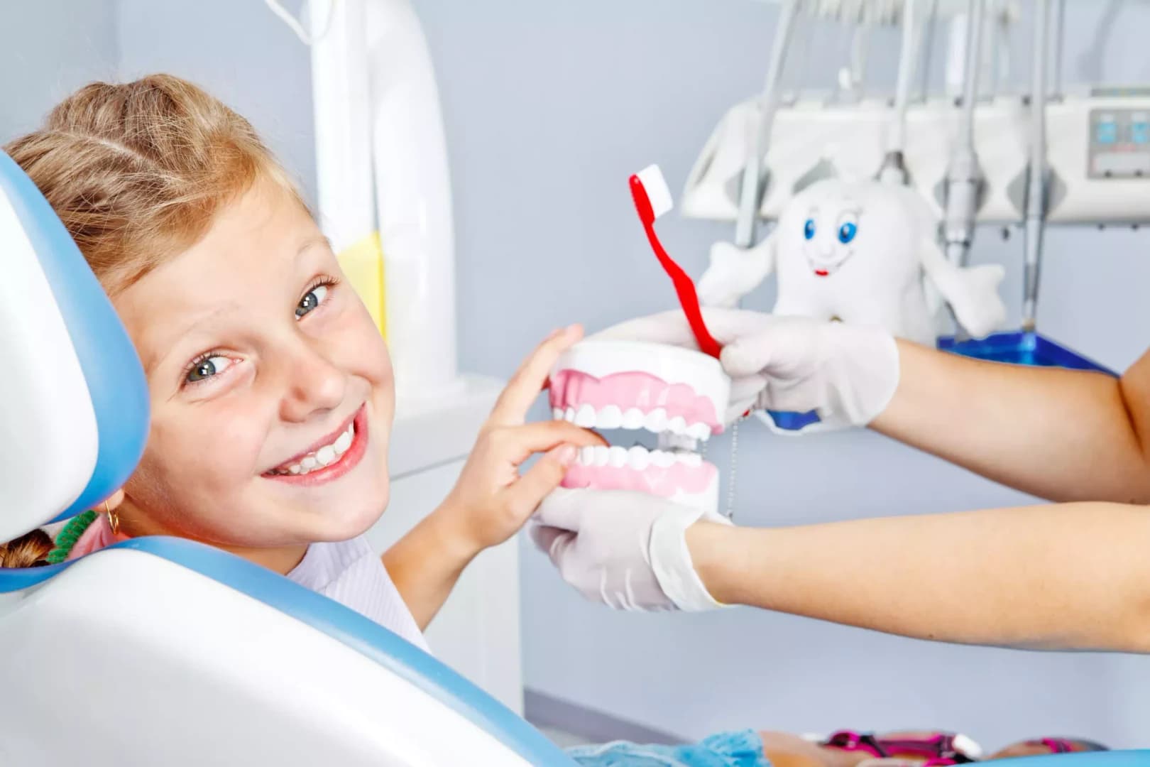 A child smiling in the dental chair during a gentle checkup