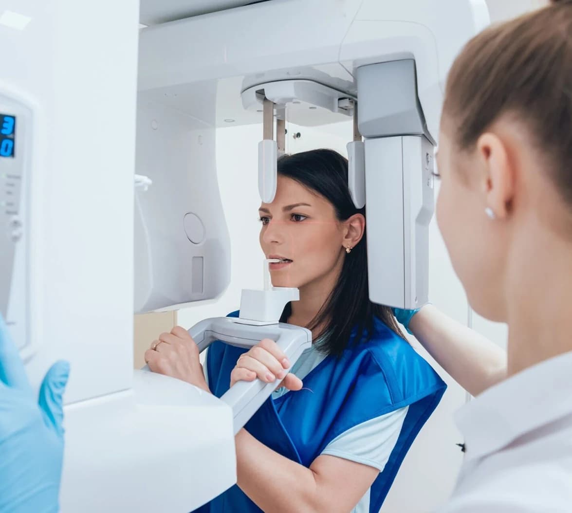 Dentist reviewing a 3D cone-beam scan of a patient's jaw