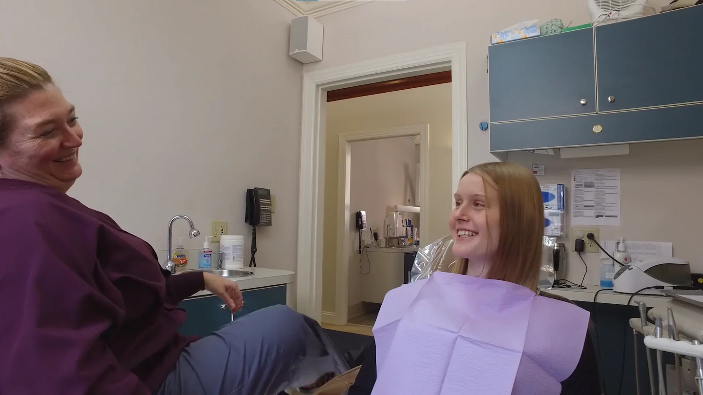 A patient smiling with a team member during a consultation