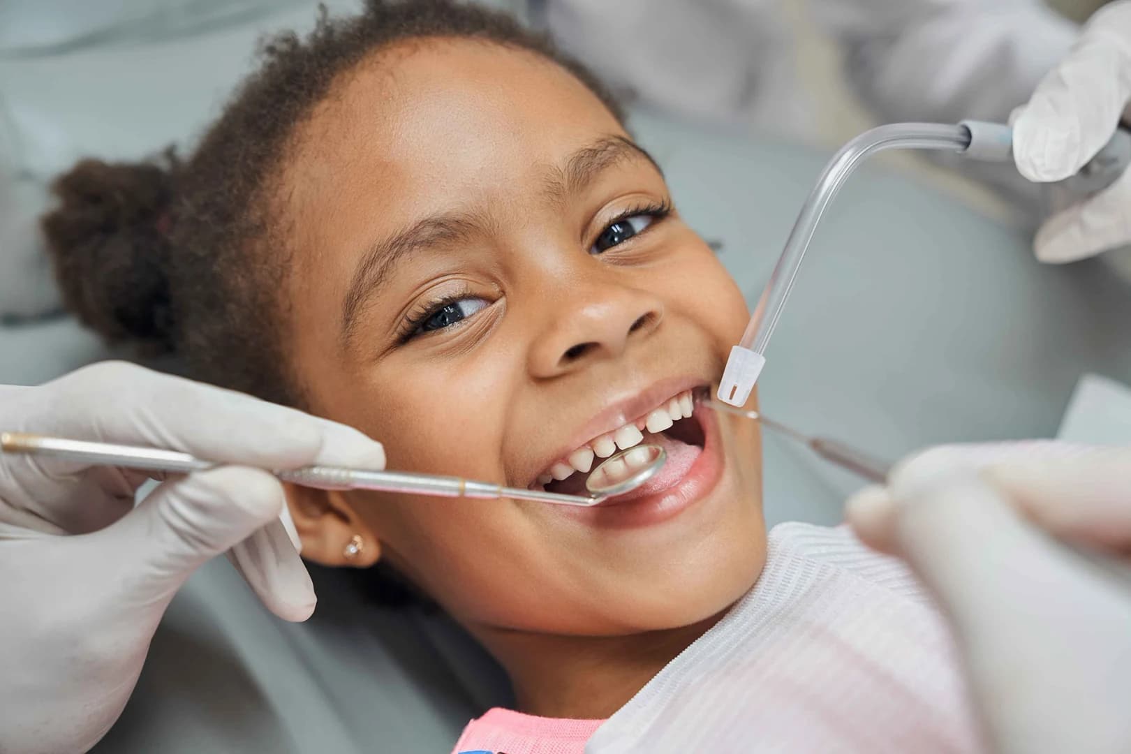 A dentist gently treating a young patient