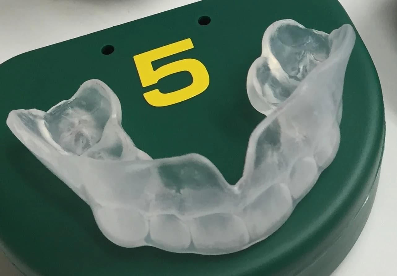 Dentist fitting custom sports mouthguards