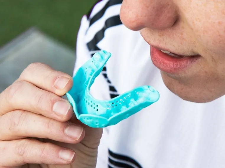 Dentist fitting custom sports mouthguards
