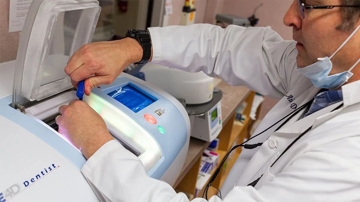 A clinician reviewing a patient's 3D dental scan on screen