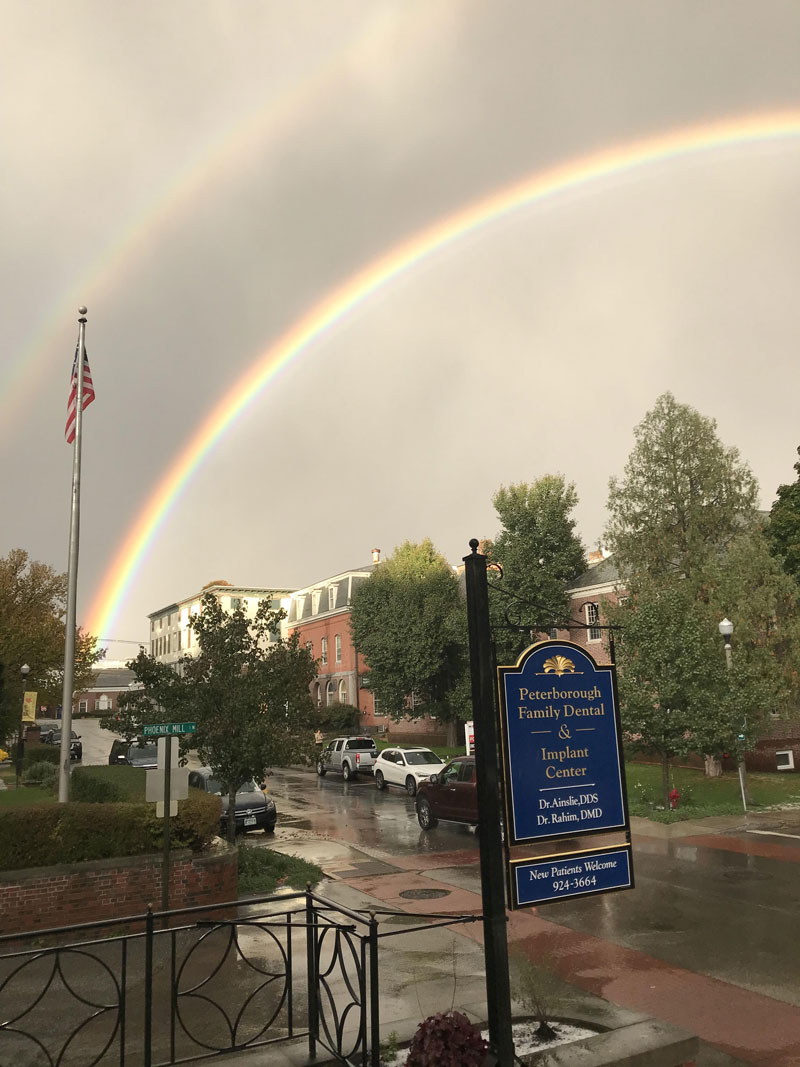 Office sign with double rainbow background